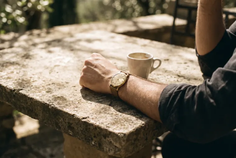 Richard's wrist wearing the watch, on a sunlit terrace table